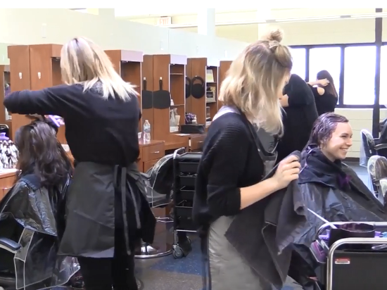 Cosmetology students working with hair