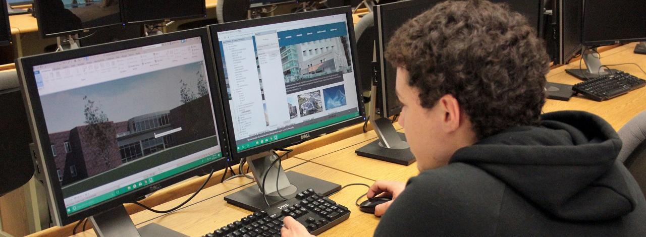 Architectural and engineering student viewing computer model of Kaskaskia College campus.