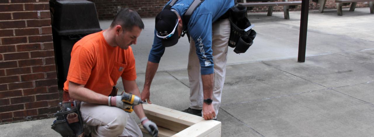 Students constructing wooden frame