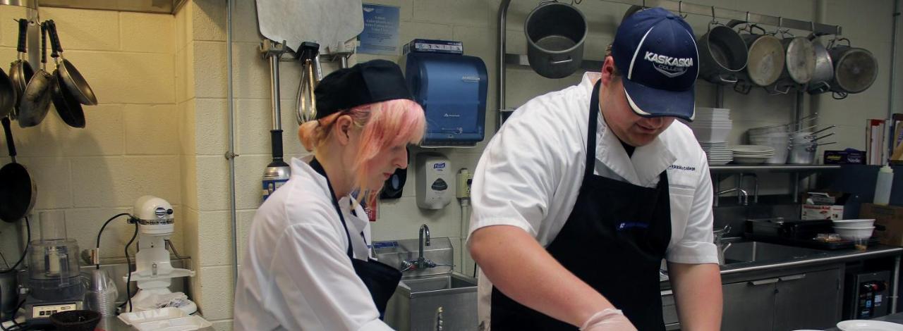 Culinary Art students preparing a dish in the kitchen