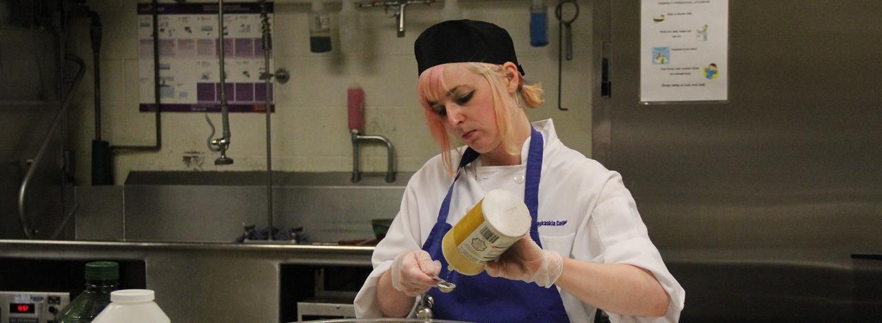 A student helps prepare food for KC event.