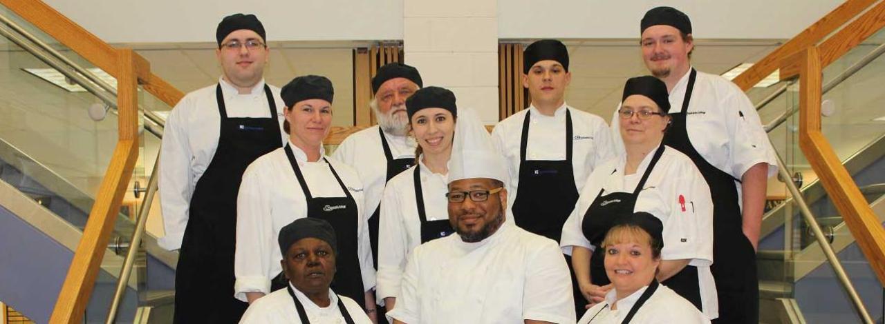 Culinary Students with Chef standing on stairs
