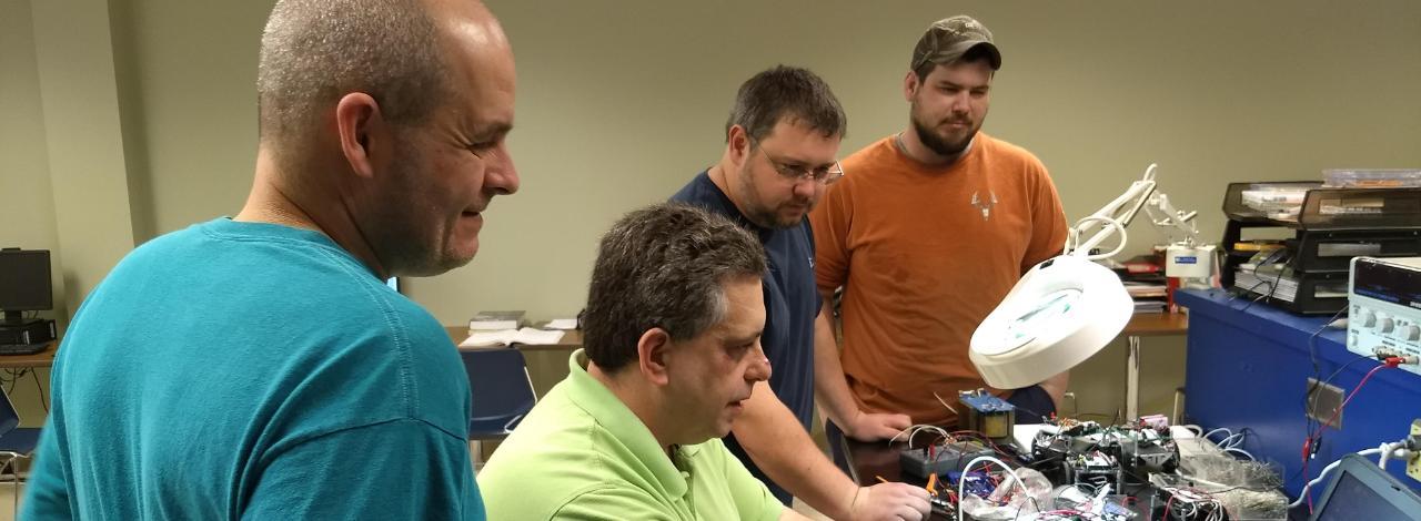 Instructor Instructor Lyle Gross showing students working images on computer.