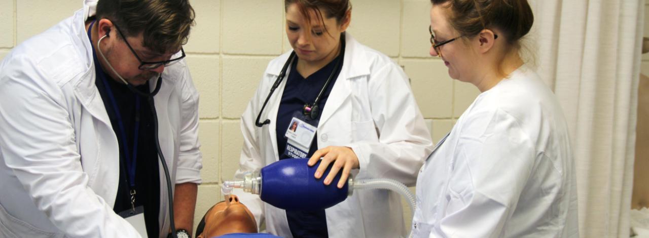 Respiratory students working on a mannequin