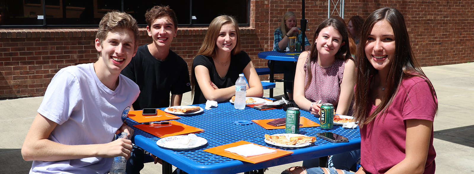 Students setting at picnic table