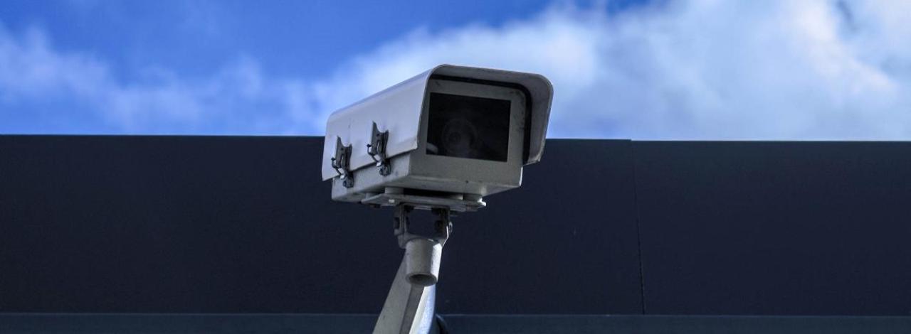 Security camera attached to the side of a building