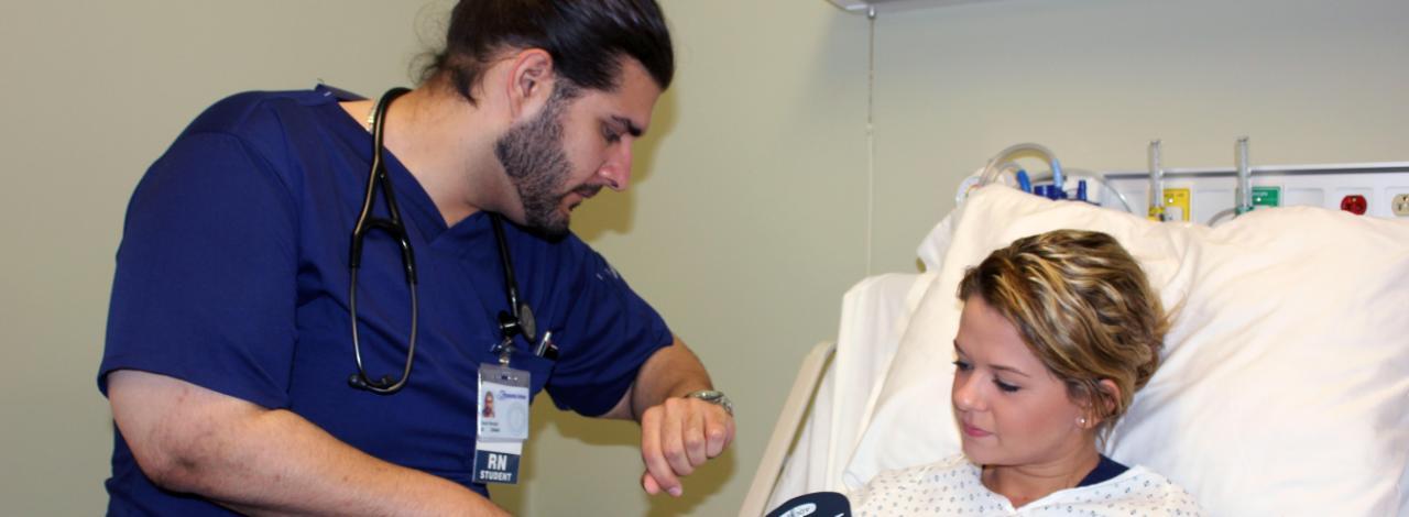 Student checking pulse of another student